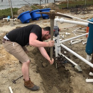 Max Rintoul working on the plumbing system for the Aquaculture Facility.