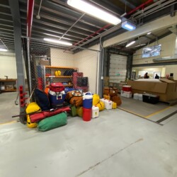 Organized field gear, including large box in the background
