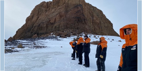 Field trainees hiking up to Castle Rock, following our trainer who cut steps in the icey snow with a shovel