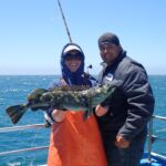 Bonnie B. with angler Joseph F. holding a green Lingcod (Ophiodon elongatus) Bonnie B. and Joseph F. holding a green lingcod on a CCFRP trip