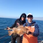 Nick I. with Bonnie B displaying a Brown Rockfish (Sebastes auriculatus) Nick I. and Bonnie B. with a brown rockfish on a CCFRP trip