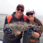 Chris L. and Jen C. showing off a Lingcod (Ophiodon elongatus) Chris L. and Jen C. holding up a lingcod on a CCFRP trip