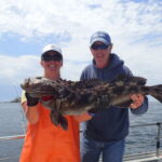 Bonnie B. with Matt M. showing off a Lingcod (Ophiodon elongatus) Bonnie B. and Matt M. holding a lingcod on a CCFRP trip