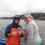 Bonnie B. with Manna C. holding a Kelp Rockfish (Sebastes atrovirens) Bonnie B. and Manna C. with a Kelp rockfish on a CCFRP trip