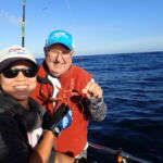 Jen C with Mike I. showing off his fancy Starfish Jen C. and Mike I. with a hooked starfish on a CCFRP trip