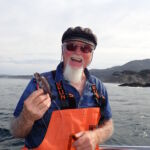 Frank P. and his baby Blue Rockfish (Sebastes mystinus) Frank P. with a tiny juvenile blue rockfish on a CCFRP trip