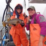 Bonnie B. holding an Olive Rockfish (Sebastes serranoides) that Katie C. caught Bonnie B and Katie C. with an olive rockfish on a CCFRP trip