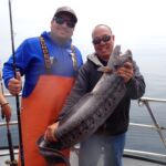 Manny D, and Captain Allen C. facing down a Wolf Eel (Anarrhichthys ocellatus) Manny D. and Captain Allen C. with a wolf eel on a CCFRP trip