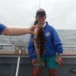 A volunteer angler with her Kelp Bass (Paralabrax clathratus) prior to release A volunteer angler with her Kelp Bass (Paralabrax clathratus) prior to release