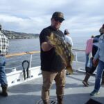 A volunteer angler holding a Kelp Bass (Paralabrax clathratus) that was caught and released on the F/V Sum Fun A volunteer angler holding a Kelp Bass (Paralabrax clathratus) that was caught and released on the F/V Sum Fun