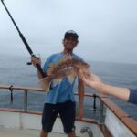 A volunteer angler with his Kelp Rockfish (Sebastes atrovirens) prior to release A volunteer angler with his Kelp Rockfish (Sebastes atrovirens) prior to release