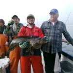 Wyatt P., Zach K. and Buck M. with a Lingcod (Ophiodon elongatus) and some regurgitated stomach contents Wyatt P., Zach K. and Buck M. with a Lingcod (Ophiodon elongatus) and some regurgitated stomach contents