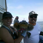 Ellie B. and Eddie G. show off that adorable Cabezon (Scorpaenichthys marmoratus) face Ellie B. and Eddie G. show off that adorable Cabezon (Scorpaenichthys marmoratus) face