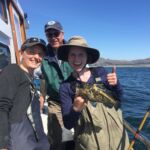 Our captain, science crew member and volunteer angler all in one photo showing off a China Rockfish (Sebastes nebulosus) Our captain, science crew member and volunteer angler all in one photo showing off a China Rockfish (Sebastes nebulosus)