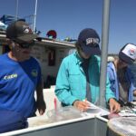 Captain Joe of the F/V Sea Starr and SIO science crew looking over the datasheets Captain Joe of the F/V Sea Starr and SIO science crew looking over the datasheets