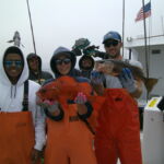 Science crew and volunteers showing off their catch prior to release Science crew and volunteers showing off their catch prior to release