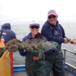 Jen C. and Kris H. with a vividly blue Lingcod (Ophiodon elongatus) Jen C. and Kris H. with a lingcod on a CCFRP trip