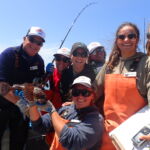 Science crew members Rick S., Ryan F., Jen C., Bonnie B., Katie C., Rachel B., and Jackie M., enjoy one of our favorite catches - the cabezon!