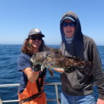Jake T. and Michie holding a beautiful tagged cabezon