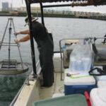 Collecting sediment for the SD TMDL study. Billy is ready to secure the grab while Rusty operates the winch. This site was in the Switzer Creek area of San Diego Bay. Collecting sediment for the SD TMDL study. Billy is ready to secure the grab while Rusty operates the winch. This site was in the Switzer Creek area of San Diego Bay.
