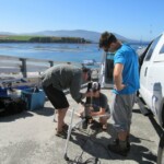 Tom Connolly, Lindsay Cooper, and Steven Cunningham setting up ADV at Stillwater Cove, CA