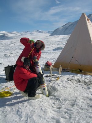 Bob Zook and Stacy Kim lower SCINI into a hole in the ice