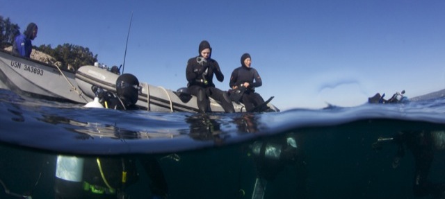 The subtidal ecology class gears up to go on an identification dive. The water temperature is 11 Celsius (52 F), so thick neoprene suits are used as thermal insulation.