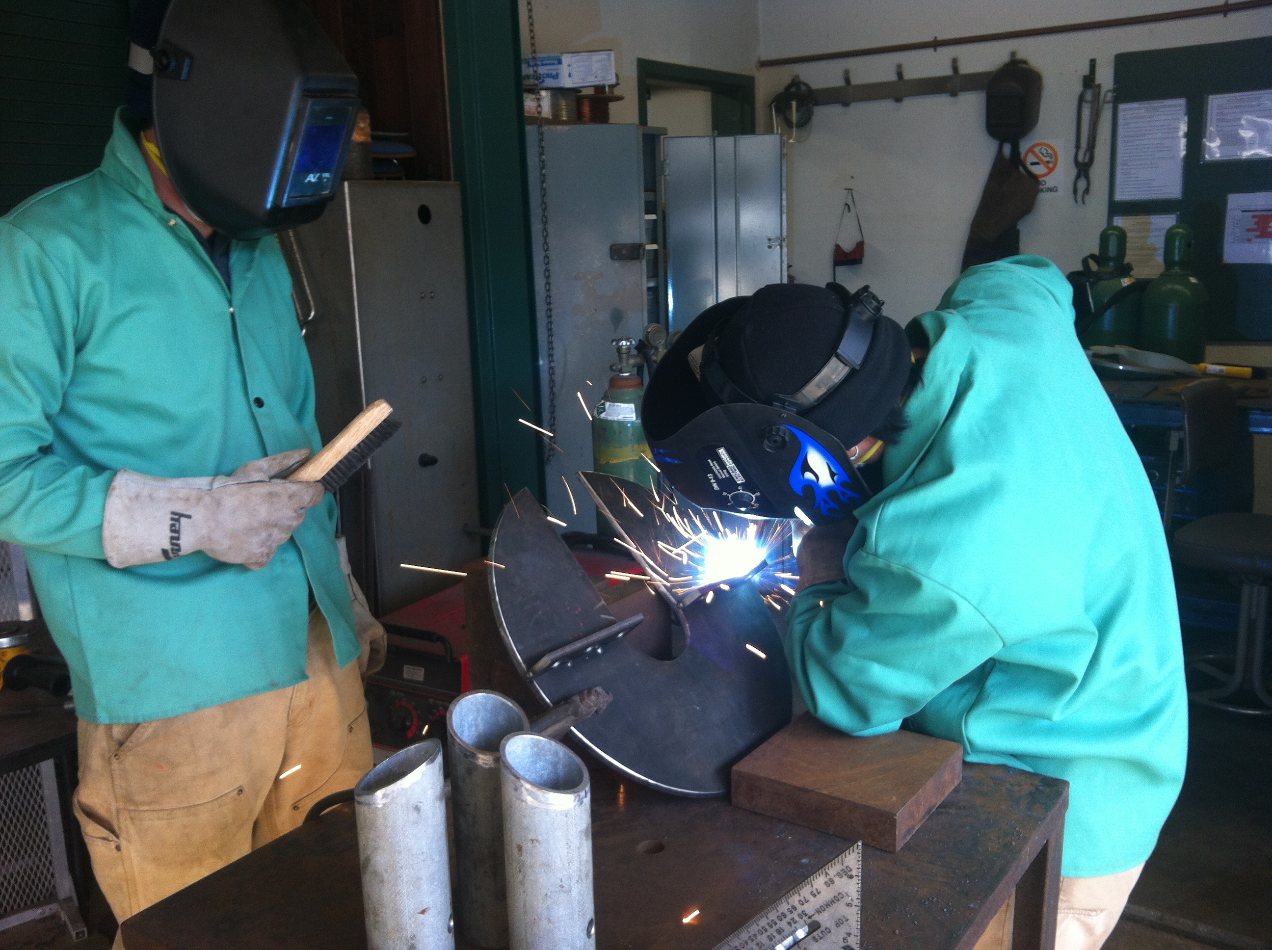 Paul Clerkin uses a MIG welder to attach pieces to the top of our tripod. Photo by: Catherine Drake