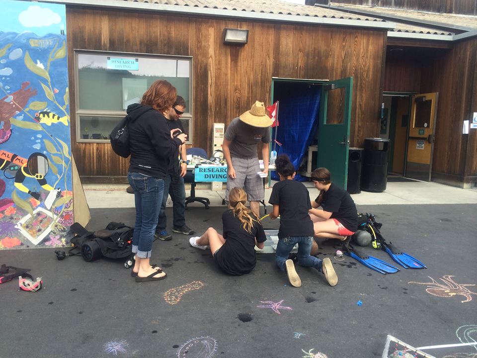 Graduate student Scott Gabara teaches visitors about dive gear. Photo Credit: Heather Kramp