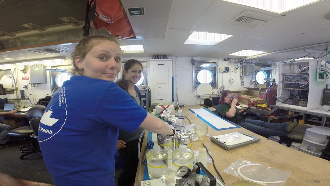Graduate students Holly Chiswell and Kristin Walovich filter samples for an onboard methylation experiment.