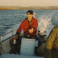 Andrew driving a MLML Whaler In Elkhorn Slough, 1985 Andrew DeVogelaere