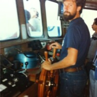 Mike at the helm of the R/V Cayuse in 1984 Mike Prince